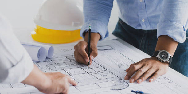 engineer meeting for an architectural project. working with partner and engineering tools working on blueprint architectural project at the construction site at desk in the office.