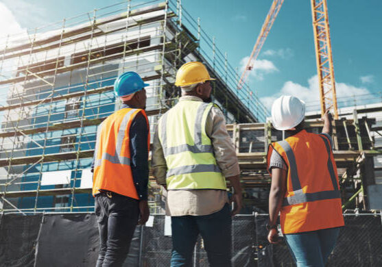 Shot of a group of builders assessing progress at a construction site