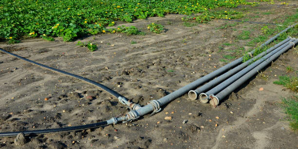 irrigation pipes in the field. water is pumped from the river and through large diameter metal pipes is led to polis melons and gourds. growing vegetables at high yield