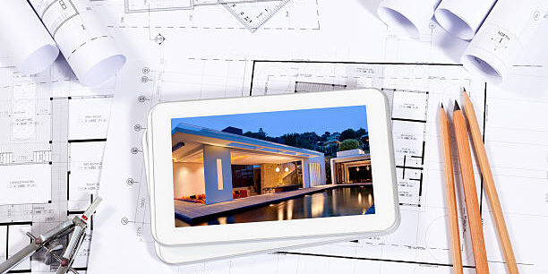 With A Digital Tablet PC And A Photo Of A House Showing On The Screen. More Like This: