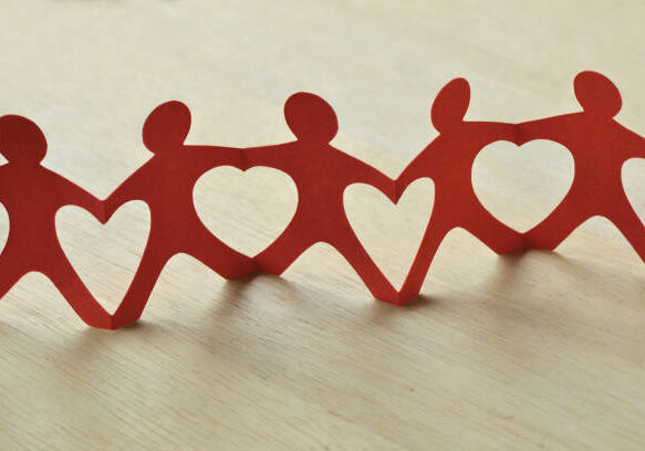 Paper people chain with hearts - Teamwork and love concept