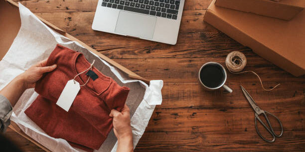 Women, owener of small business packing product in boxes, preparing it for delivery